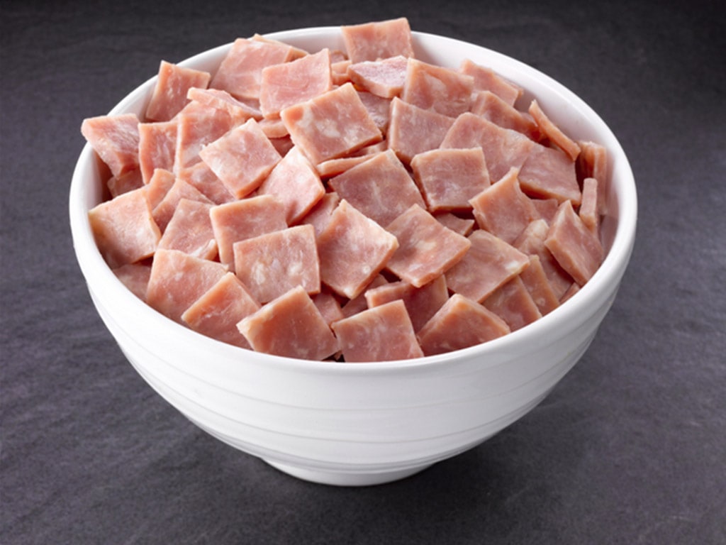 A bowl of 'ham stamps', which are square pieces ready to be used as an ingredient in any dish.