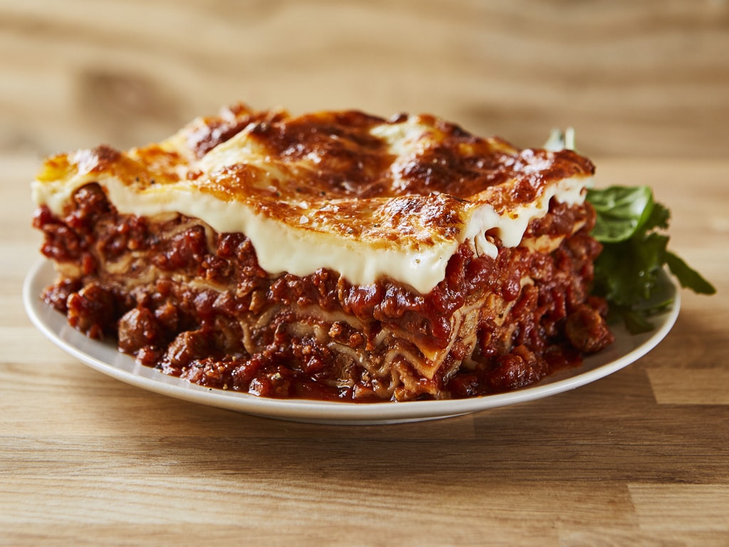 A classic slice of traditional lasagna with a vegetarian twist. Meat-free Plant Deli mince in tomato sauce bursts from layers of cheese-laden pasta sheets.