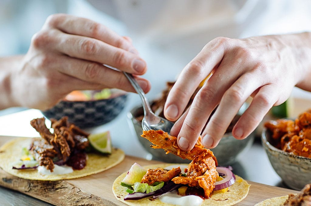 A chef in the Dawn Farms test kitchen puts the finishing touches to an array of small flour tortillas with different flavour combinations, including Beef Barbacoa and Slow Cooked Chicken Tinga.